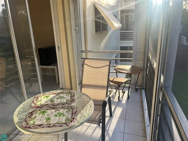 a view of a balcony with table and chairs