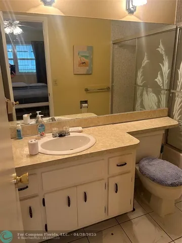 a bathroom with a sink toilet and mirror