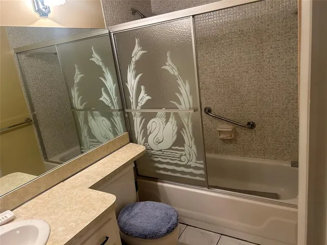 a bathroom with a shower and a sink