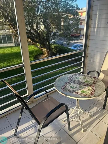 a view of a balcony with a table and chairs