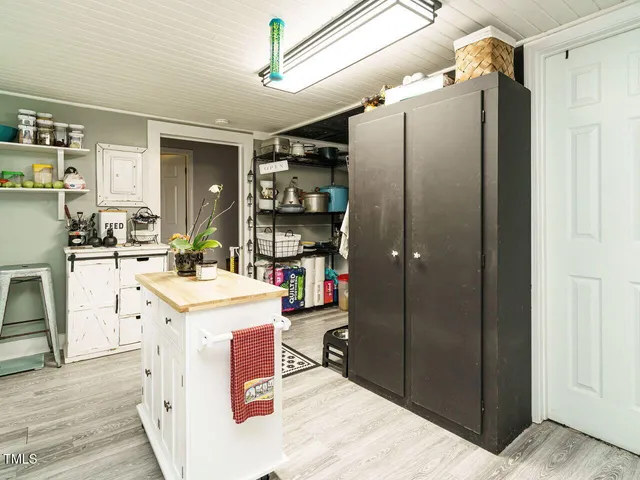 a kitchen with refrigerator and cabinets