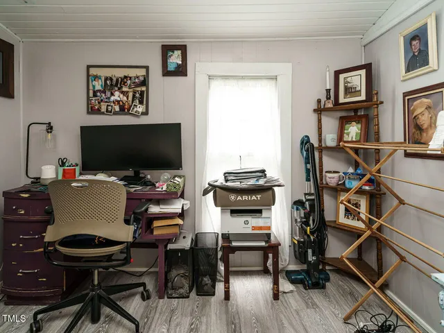a workspace with furniture and a flat screen tv