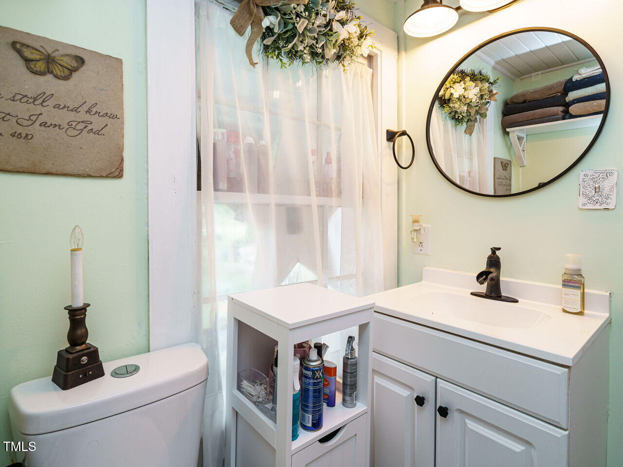 7105 Great Swamp Loop Lucama, NC 27851 - Photo 18 of 28 a bathroom with a sink and a mirror