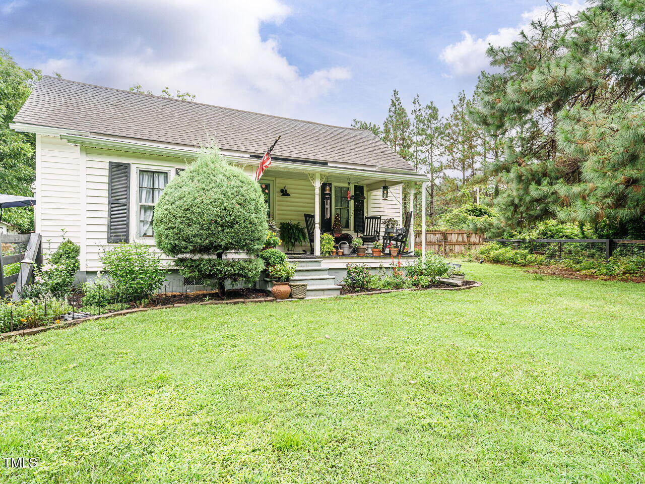 7105 Great Swamp Loop Lucama, NC 27851 - Photo 3 of 28 a front view of a house with garden