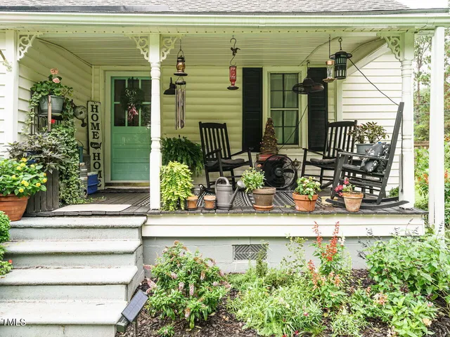 a front view of a house with potted plants