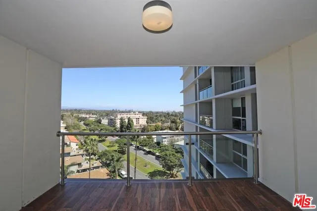 a view of a floor to ceiling window and wooden floor