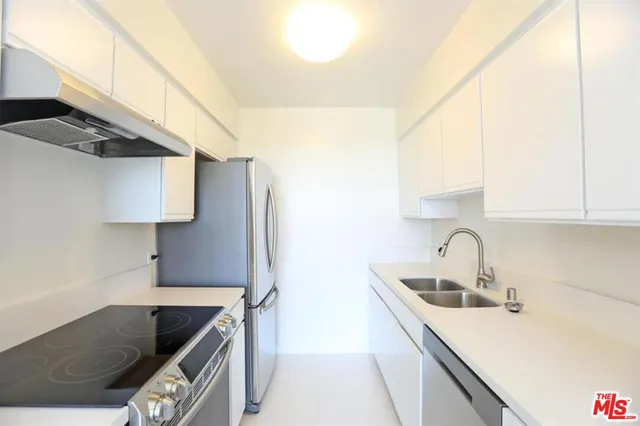 a kitchen with stainless steel appliances granite countertop a sink and a stove