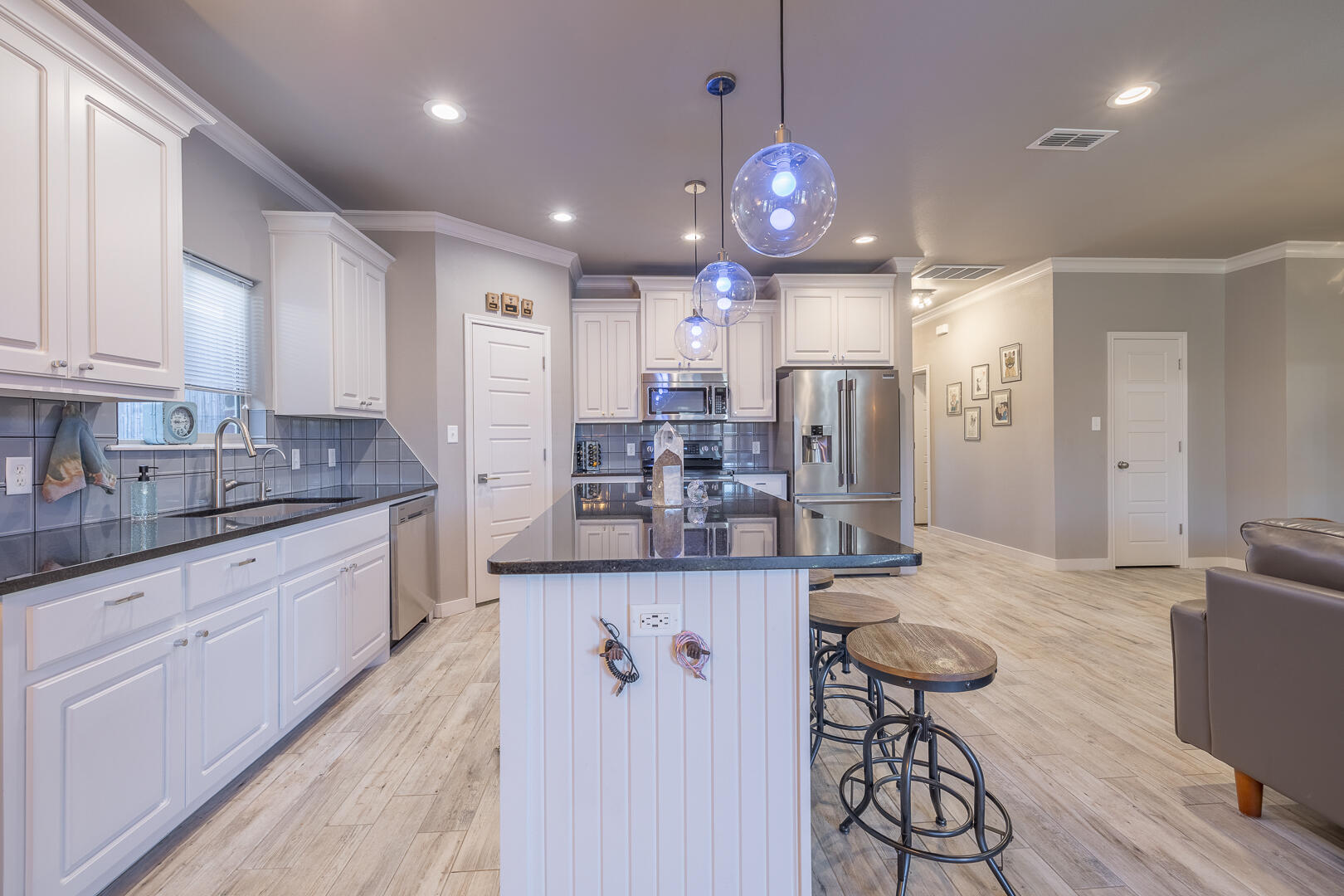 2109 101st Street Lubbock, TX 79423 - Photo 23 of 49 a kitchen with stainless steel appliances kitchen island granite countertop a sink and cabinets