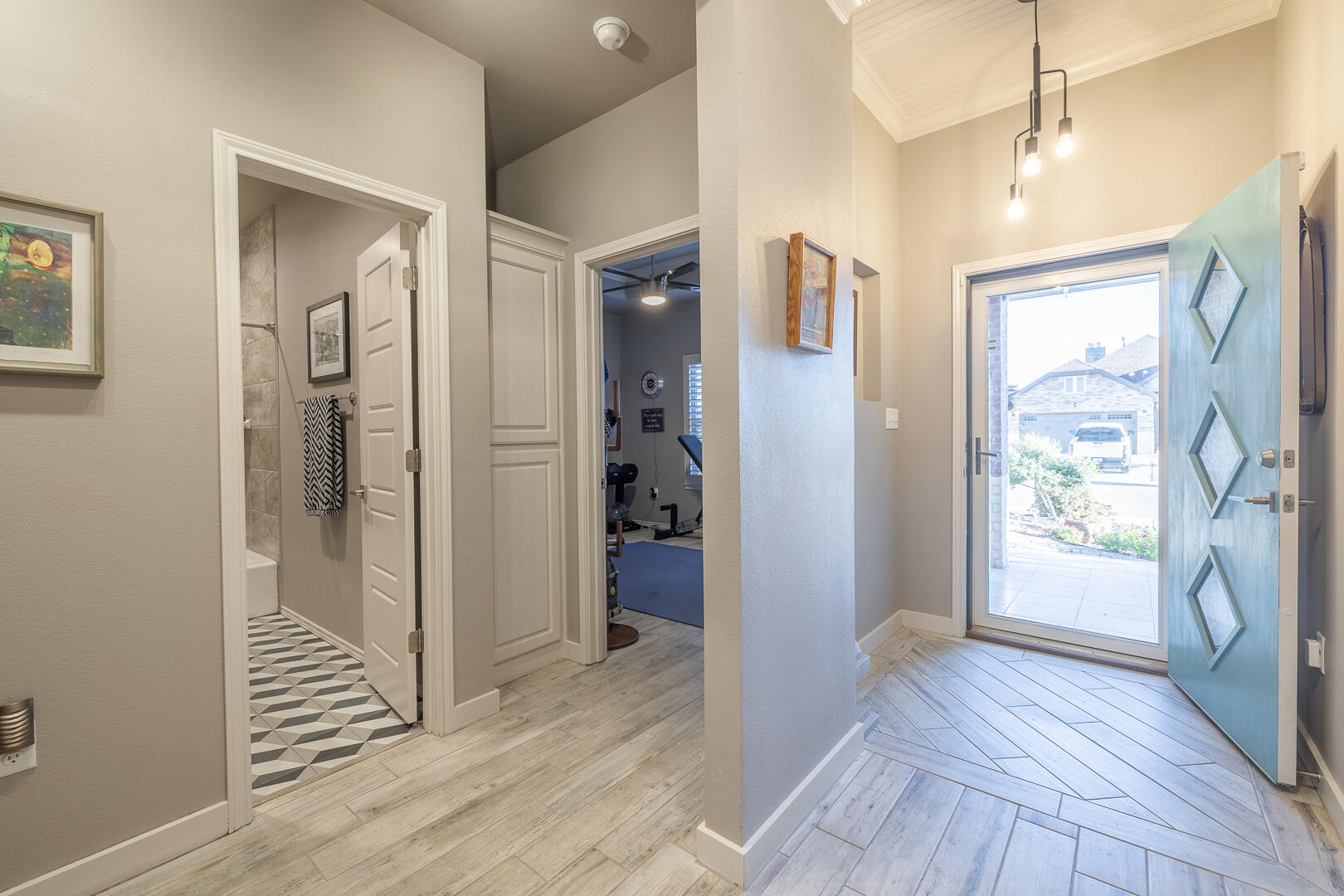 2109 101st Street Lubbock, TX 79423 - Photo 6 of 49 a view of a hallway with wooden floor and a bathroom