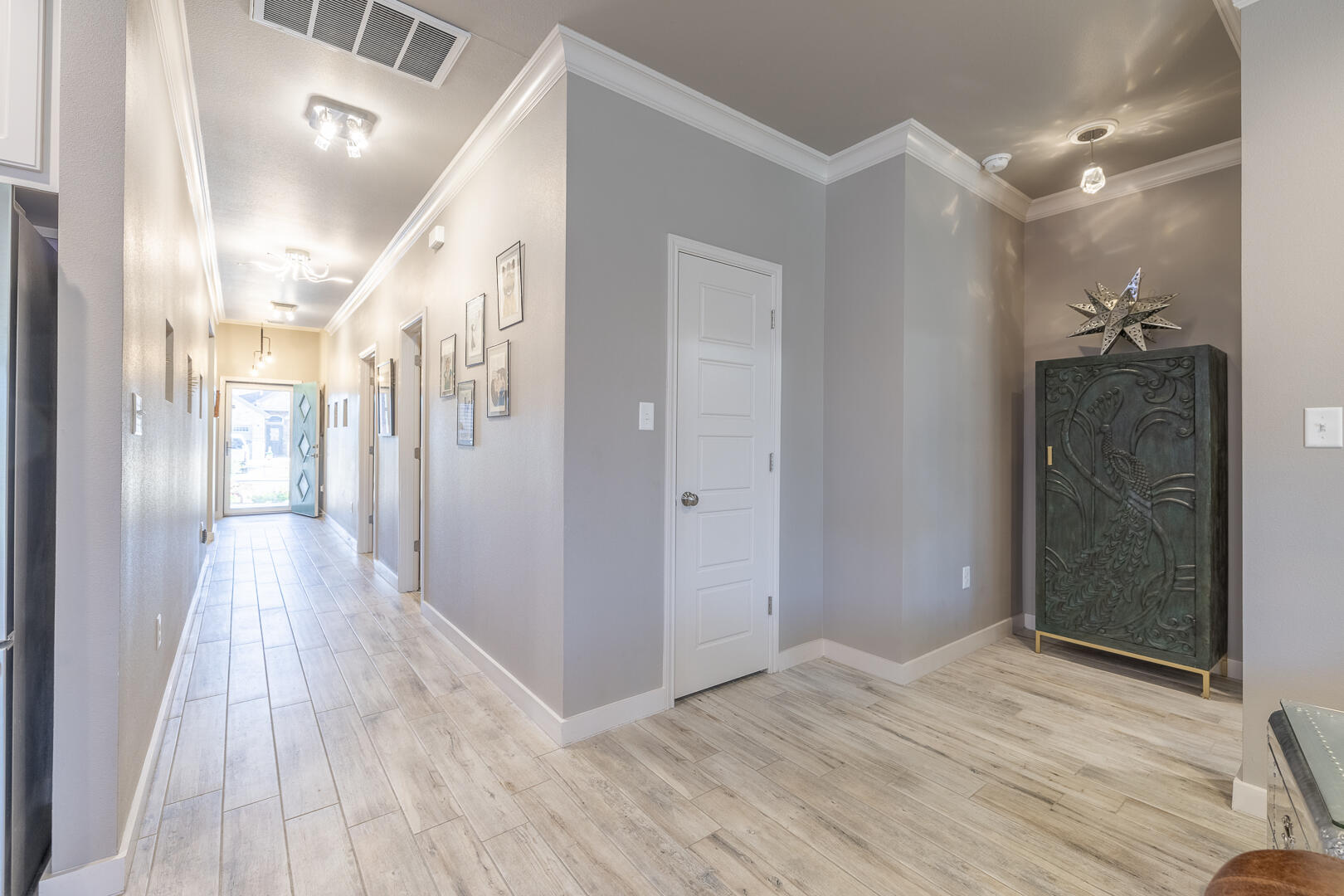 2109 101st Street Lubbock, TX 79423 - Photo 7 of 49 a view of a hallway with wooden floor