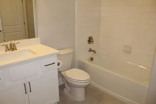a bathroom with a sink a toilet and a bathtub