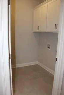 a view of small space with white cabinets and a window