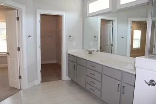 a bathroom with a double vanity sink a and mirror