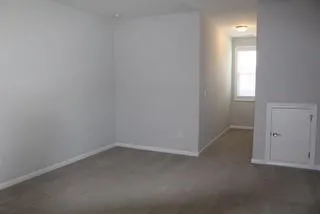 an empty room with a empty space and windows