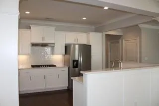 a kitchen with a refrigerator and a sink