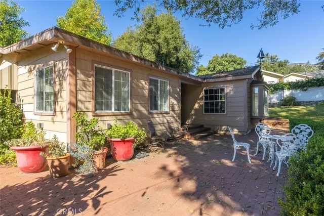a front view of a house with outdoor seating yard