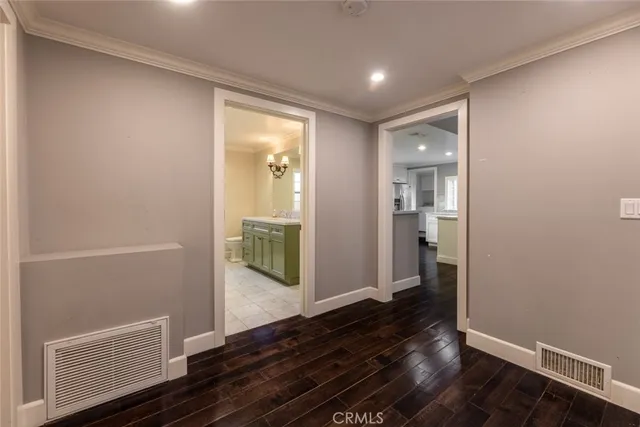 a view of hallway with wooden floor