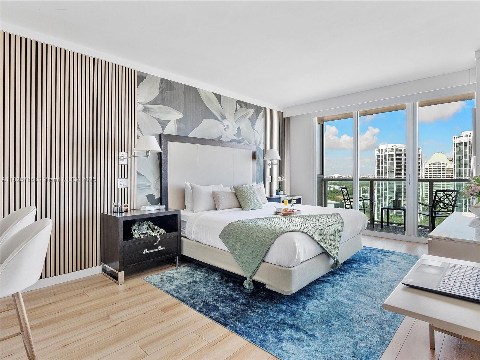 2889 McFarlane Road, Unit 1908 Miami, FL 33133 - Photo 13 of 26 a spacious bedroom with a bed a couch and large window with balcony view