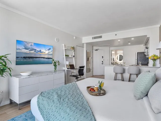 a living room with furniture a rug and white walls