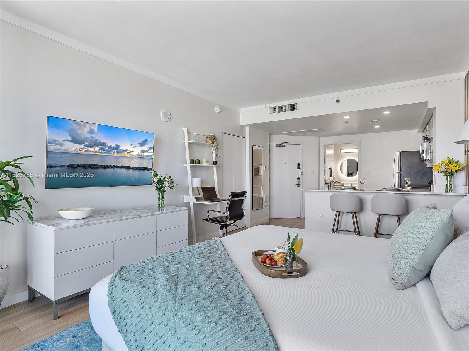 2889 McFarlane Road, Unit 1908 Miami, FL 33133 - Photo 20 of 26 a living room with furniture and a wooden floor