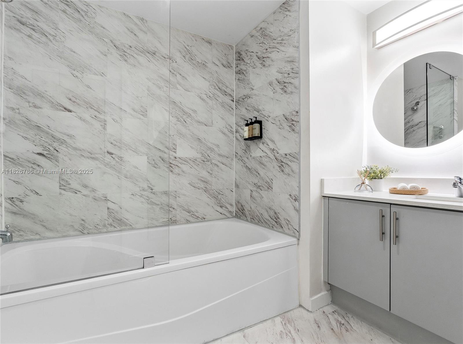 2889 McFarlane Road, Unit 1908 Miami, FL 33133 - Photo 23 of 26 a bathroom with a bathtub and a sink