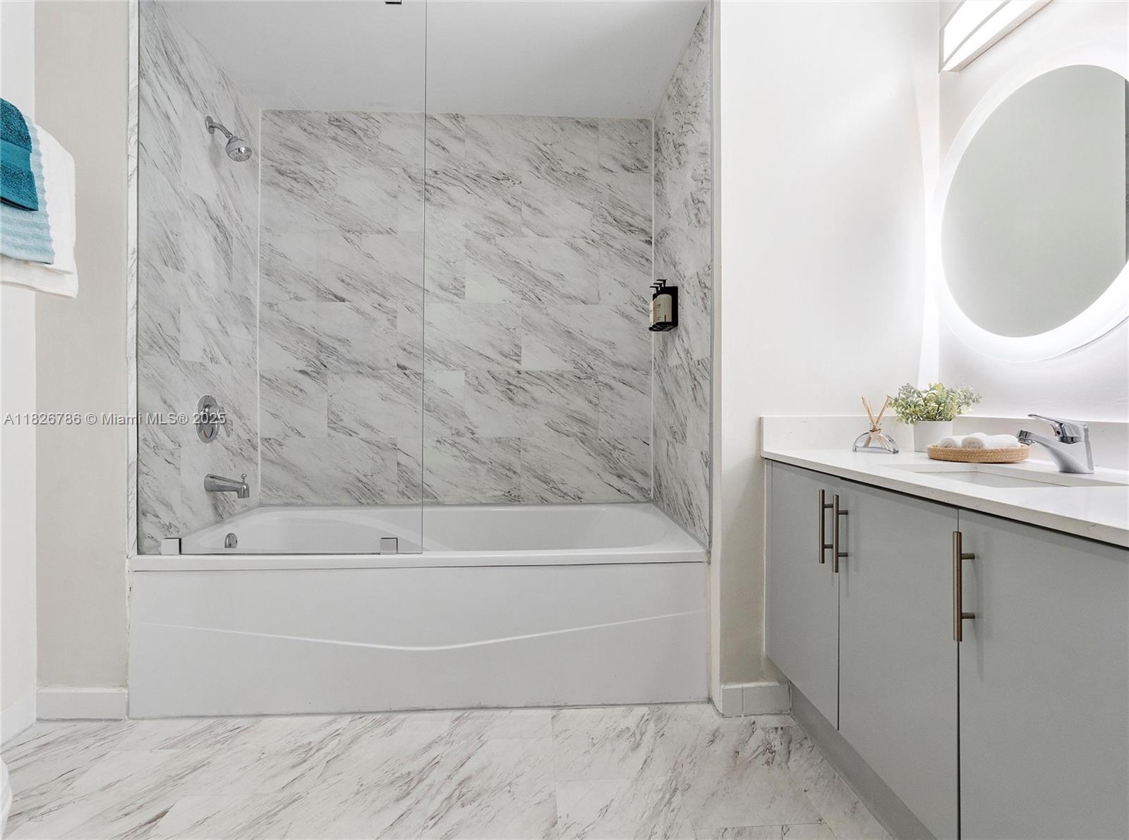 2889 McFarlane Road, Unit 1908 Miami, FL 33133 - Photo 24 of 26 a bathroom with a sink and a mirror