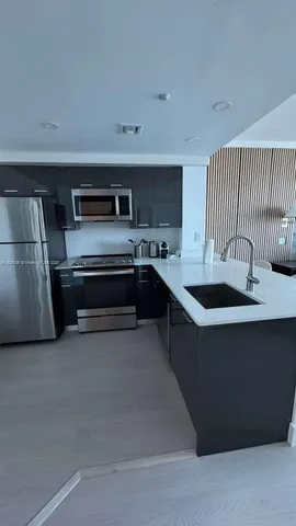 a picture of a bathroom with a white wall