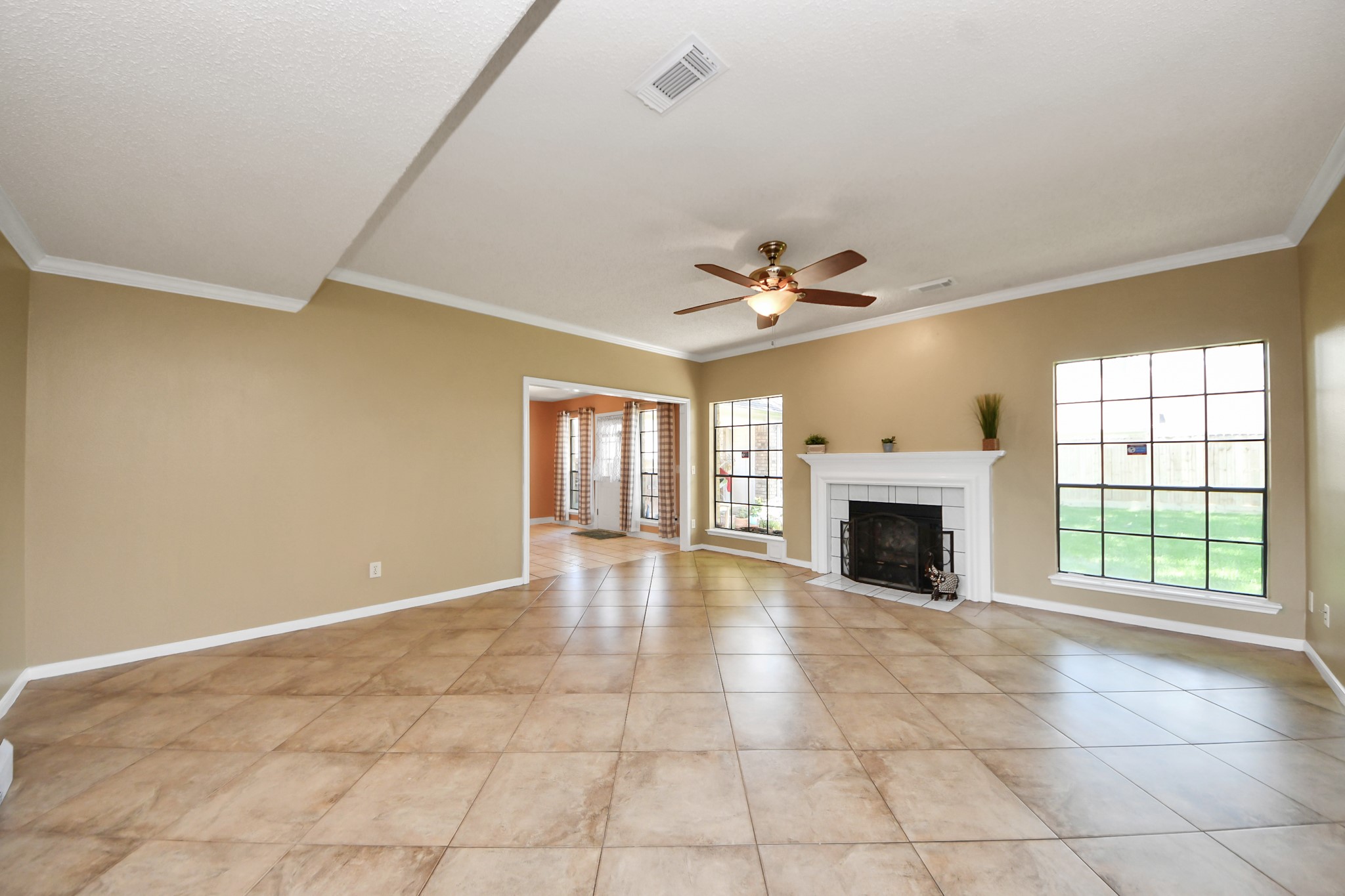 3107 Dulaney Road Houston, TX 77084 - Photo 10 of 50 a view of an empty room with a fireplace and a window