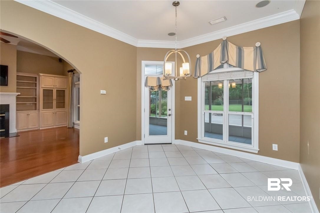 8837 Dawes Lake Road South Mobile, AL 36619 - Photo 12 of 44 Unfurnished room with ornamental molding, a chandelier, and light hardwood / wood-style floors