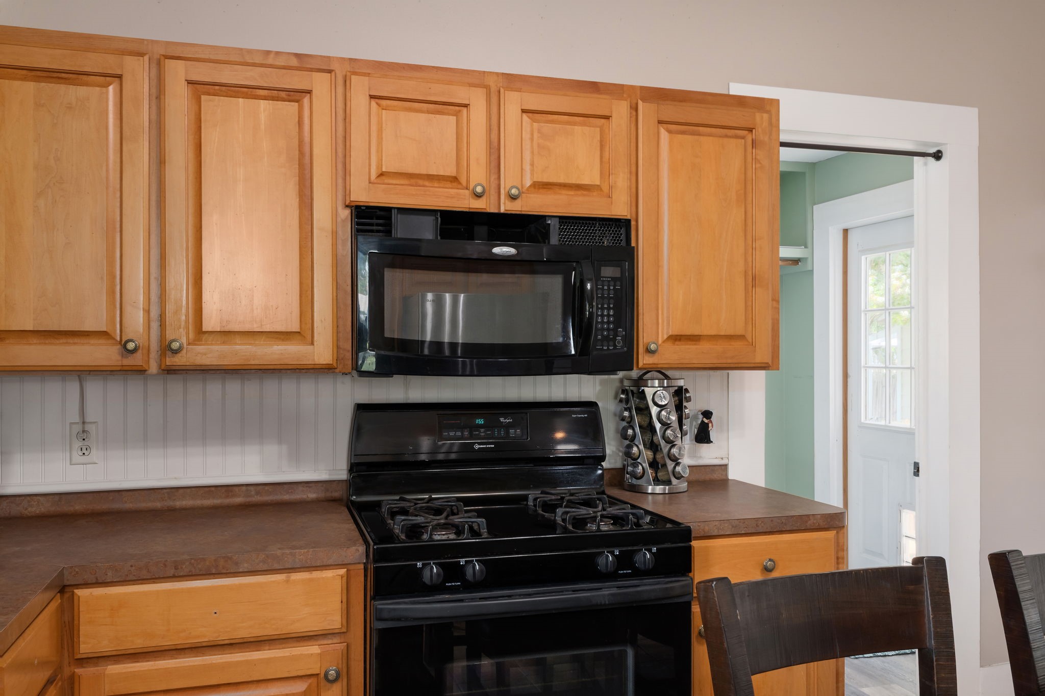 515 Wolf Street Schulenburg, TX 78956 - Photo 11 of 39 a kitchen with wooden cabinets and a stove top oven