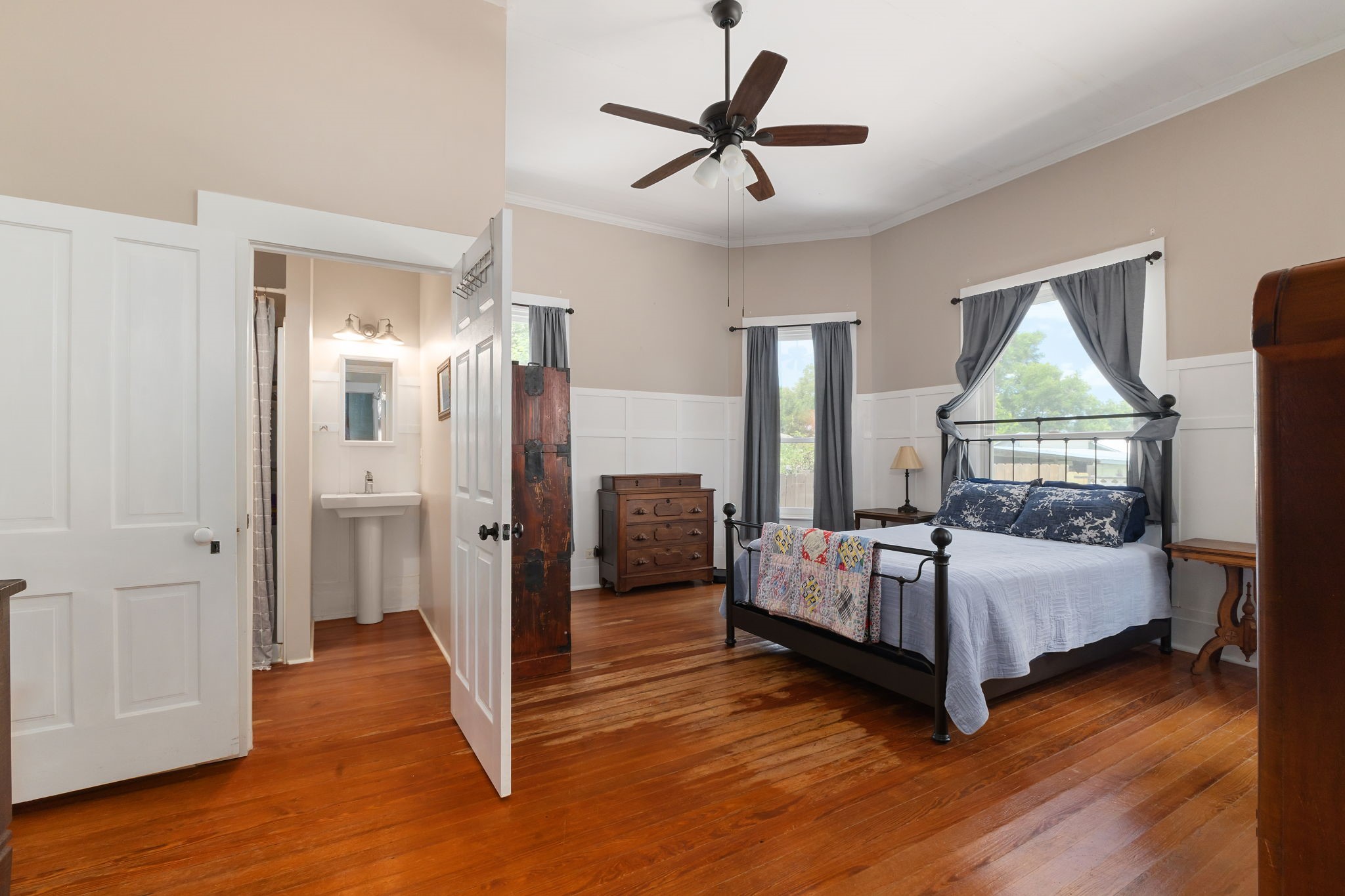 515 Wolf Street Schulenburg, TX 78956 - Photo 20 of 39 a bedroom with a bed and wooden floor