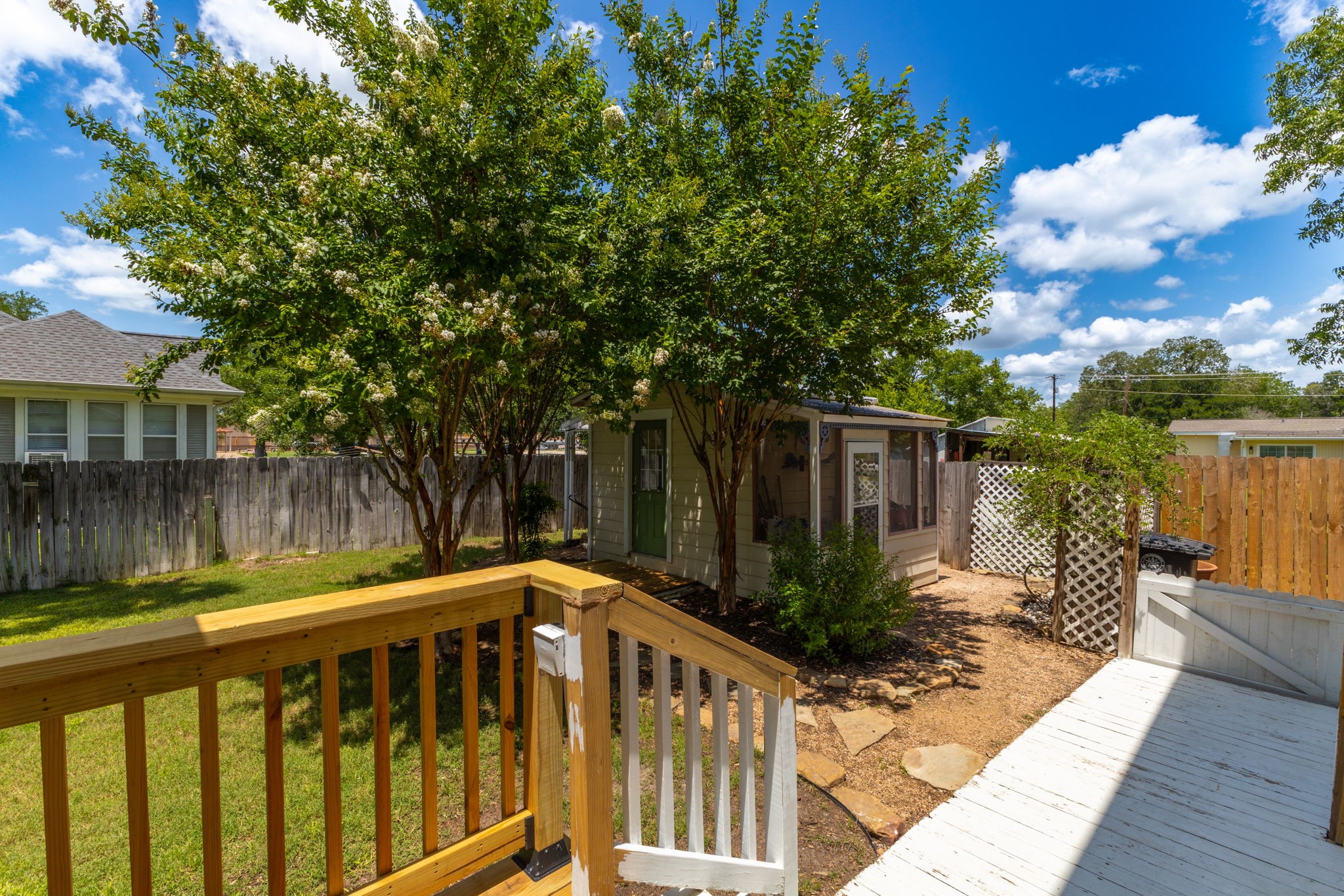 515 Wolf Street Schulenburg, TX 78956 - Photo 32 of 39 a view of deck with a large trees and wooden fence