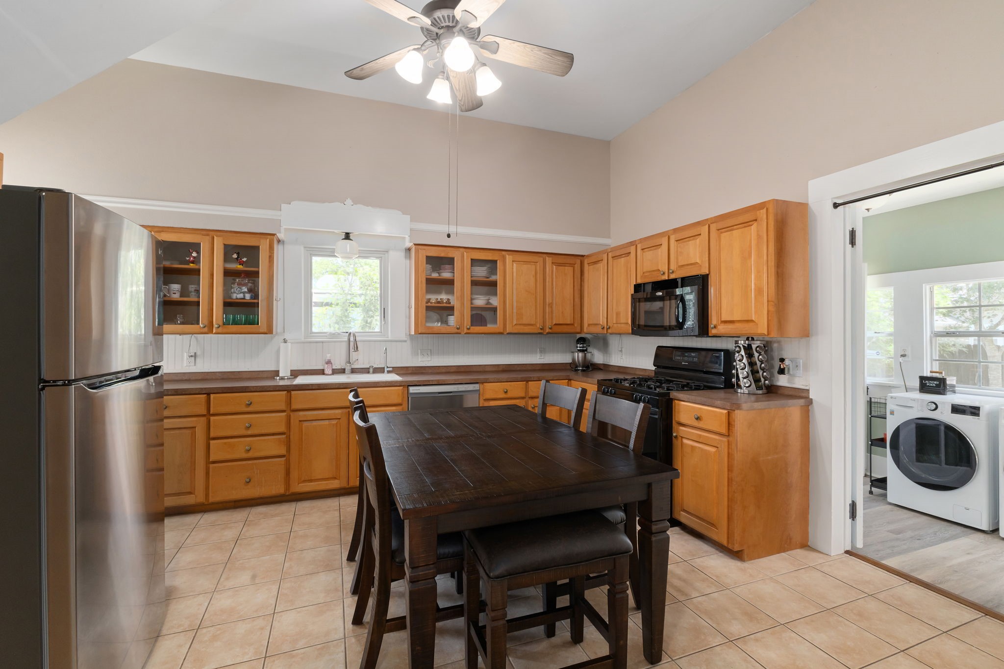 515 Wolf Street Schulenburg, TX 78956 - Photo 10 of 39 a kitchen with a table chairs refrigerator and microwave