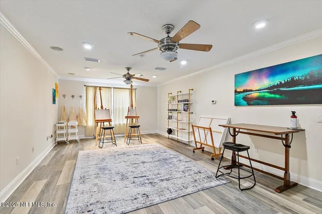 a view of a dining room with furniture a chandelier and wooden floor