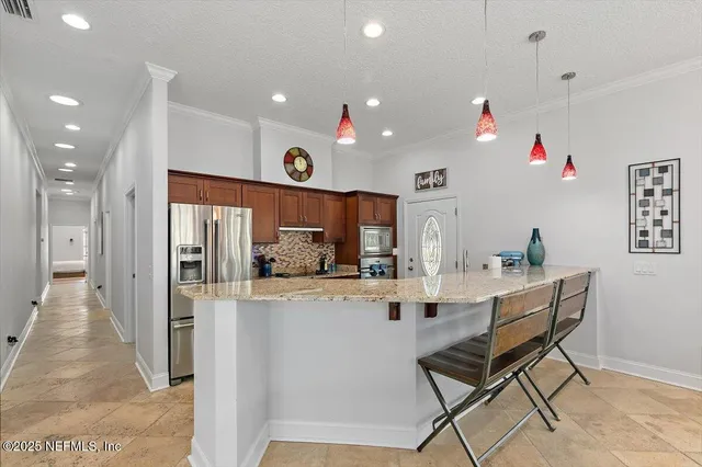 a kitchen with granite countertop a sink and a stove