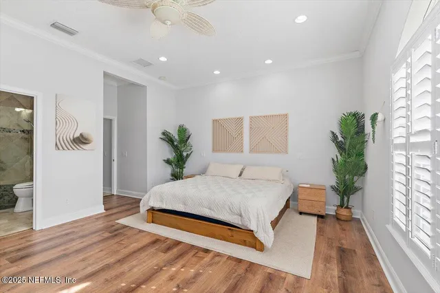 a spacious bedroom with a large bed and a chandelier