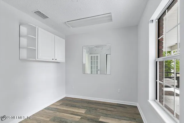 a hallway with a white cabinets
