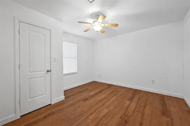 wooden floor in an empty room with a window