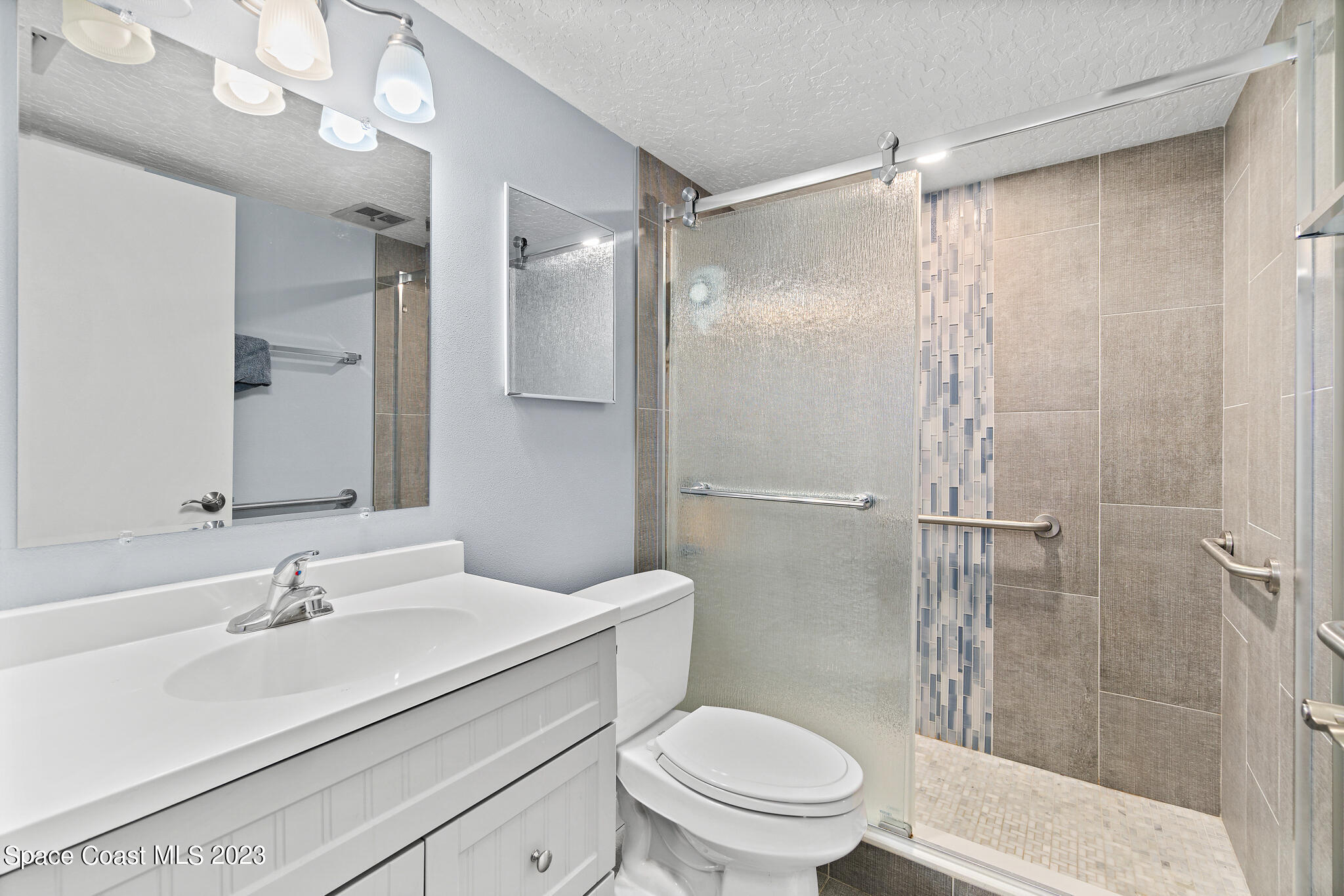 500 Catalina Road, Unit 103 Cocoa Beach, FL 32931 - Photo 17 of 28 a bathroom with a sink toilet and shower