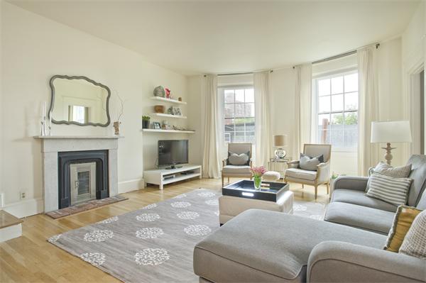 a living room with furniture window and a fireplace