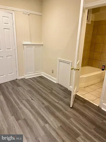 a view of a hallway with wooden floor and entryway