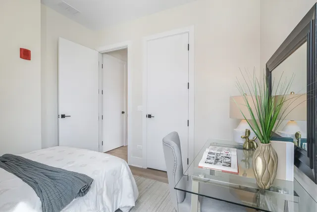 a bedroom with furniture and a potted plant
