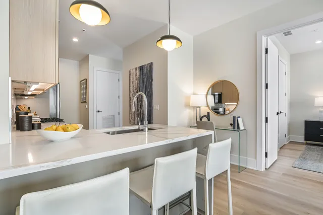 a kitchen with a sink appliances and cabinets