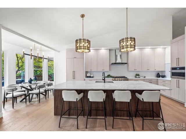 a living room with furniture a chandelier and a dining table