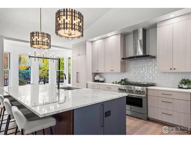 a kitchen with sink stove and cabinets