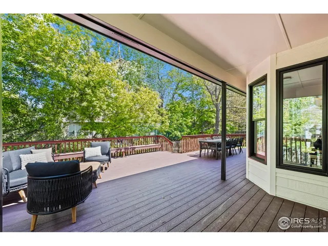 a kitchen with stainless steel appliances kitchen island granite countertop a table chairs sink and cabinets