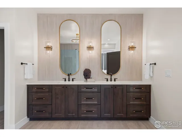 a en suite bathroom with a granite countertop sink and a mirror
