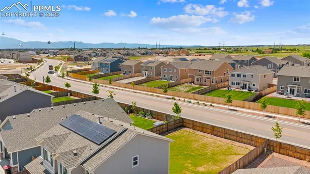 an aerial view of residential houses with outdoor space