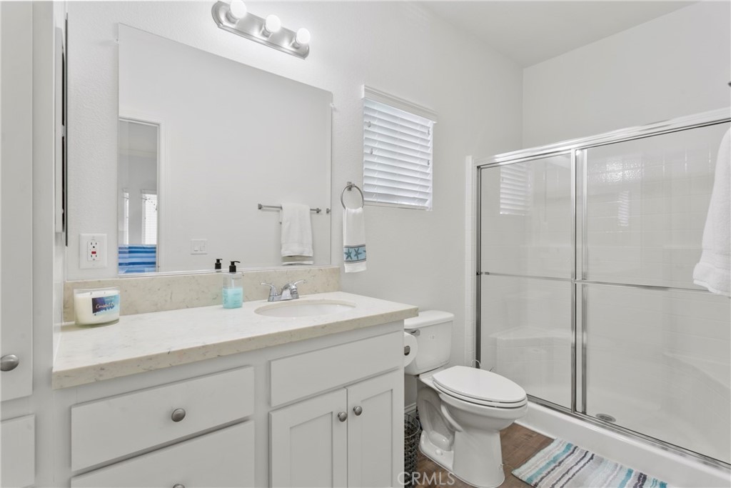108 Bay Drive San Clemente, CA 92672 - Photo 25 of 28 a bathroom with a sink a toilet a mirror and shower