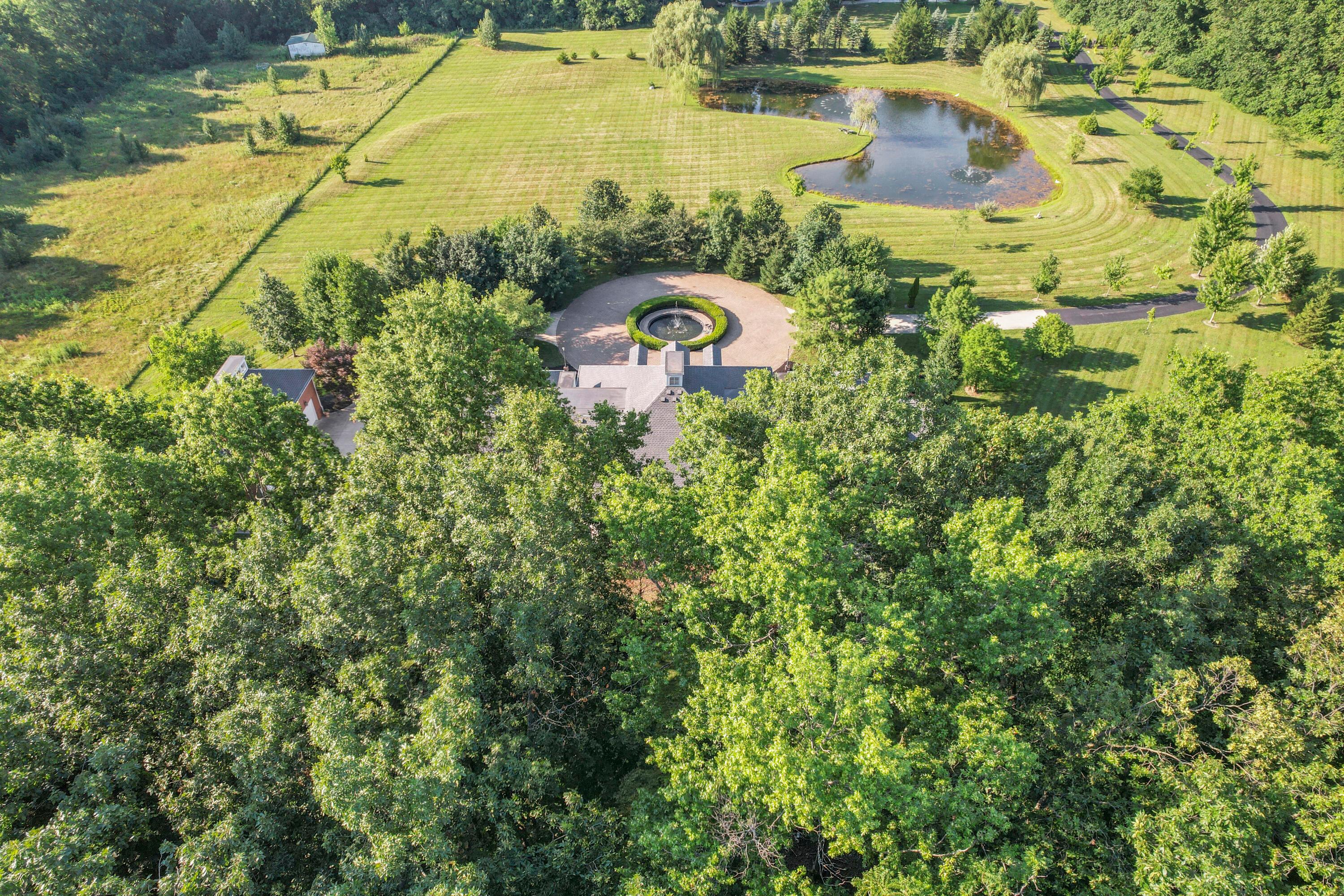 3575 State Rte 37 West Delaware, OH 43015 - Photo 18 of 106 Expansive estate featuring a large main residence, circular drive with central fountain, and a private pond